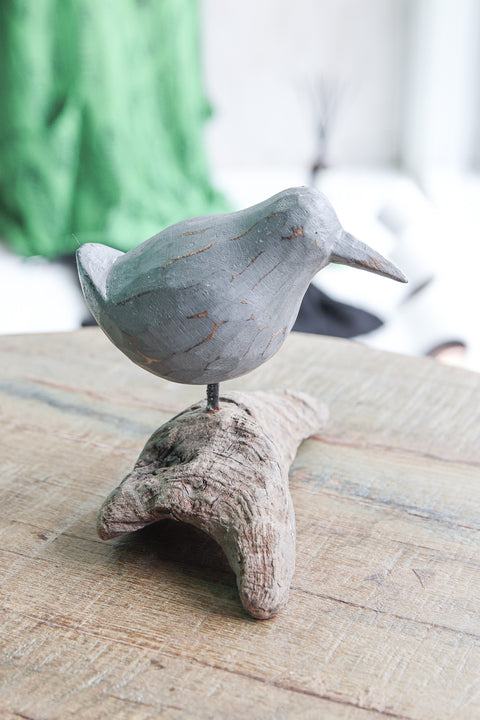 Carved bird on root